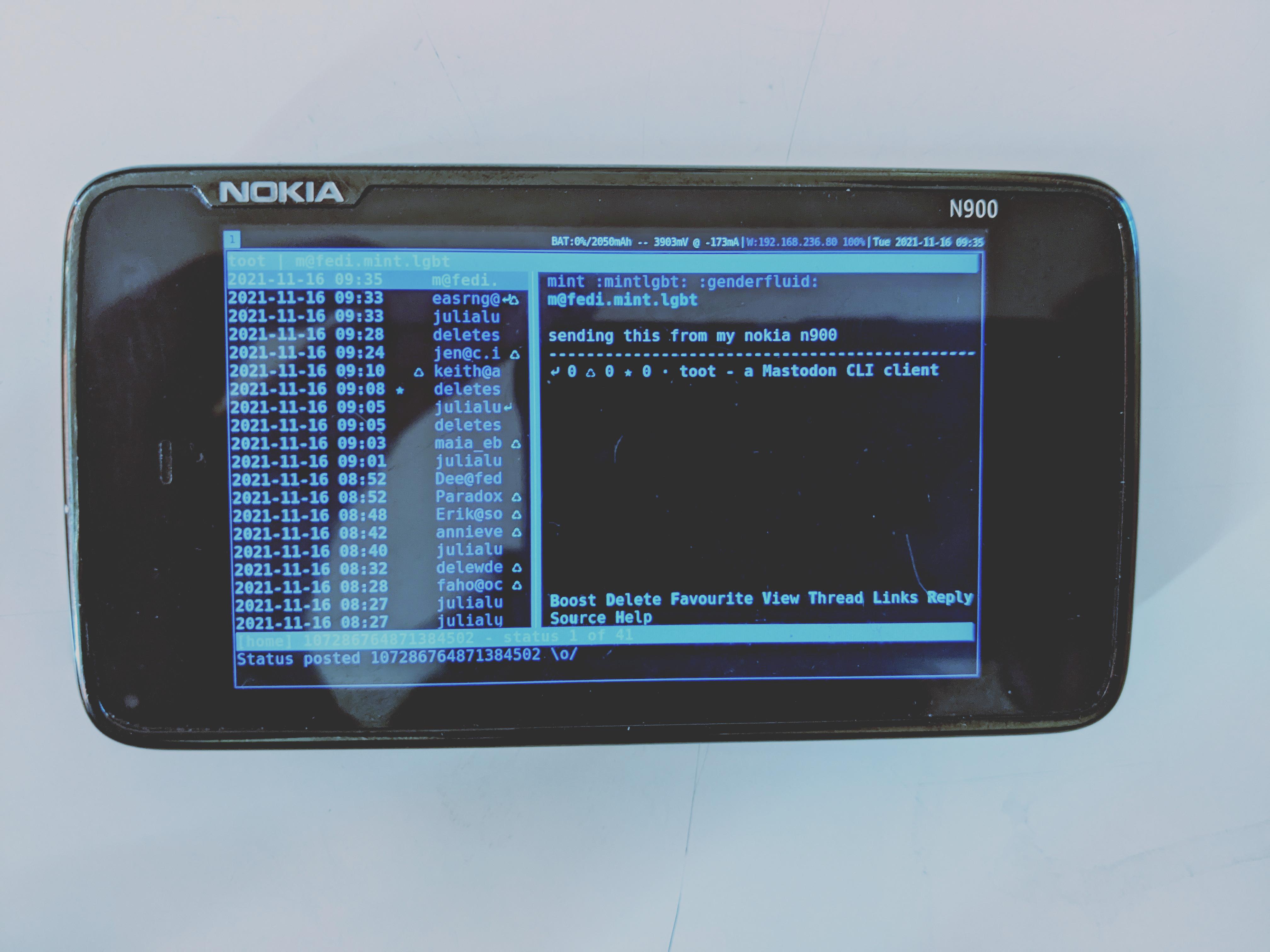 Photo of my Nokia N900 running i3wm with a terminal running toot, a TUI Mastodon client.